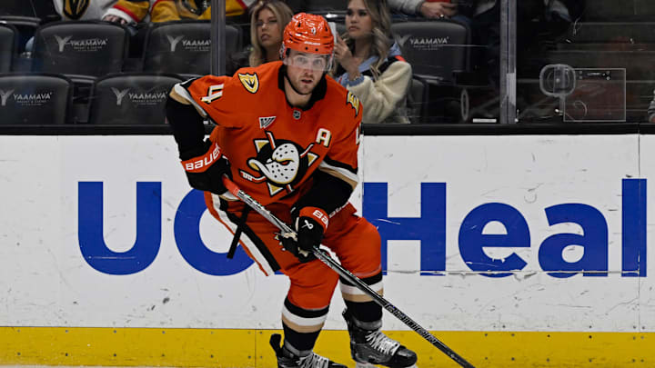 Dec 4, 2024; Anaheim, California, USA;  Anaheim Ducks defenseman Cam Fowler (4) handles the puck against the Vegas Golden Knights during the third period at Honda Center. Mandatory Credit: Alex Gallardo-Imagn Images