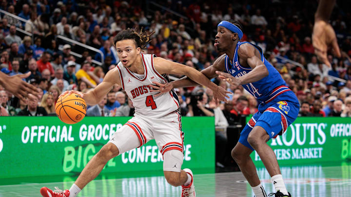 Mar 13, 2026; Kansas City, MO, USA; Houston Cougars guard Kingston Flemings (4) drives to the basket around Kansas Jayhawks guard Melvin Council Jr. (14) during the first half at T-Mobile Center. Mandatory Credit: William Purnell-Imagn Images Mar 13, 2026; Kansas City, MO, USA; Houston Cougars guard Kingston Flemings (4) drives to the basket around Kansas Jayhawks guard Melvin Council Jr. (14) during the first half at T-Mobile Center. Mandatory Credit: William Purnell-Imagn Images