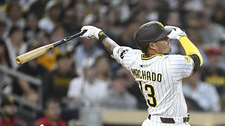 May 26, 2025; San Diego, California, USA; San Diego Padres third baseman Manny Machado (13) hits a solo home run during the eighth inning against the Miami Marlins at Petco Park. Mandatory Credit: Denis Poroy-Imagn Images