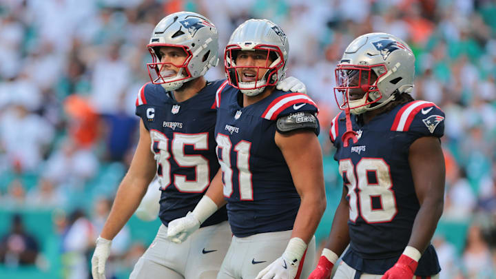 Nov 24, 2024; Miami Gardens, Florida, USA; New England Patriots tight end Austin Hooper (81) celebrates with tight end Hunter Henry (85) and running back Rhamondre Stevenson (38) after scoring a touchdown against the Miami Dolphins during the third quarter at Hard Rock Stadium.