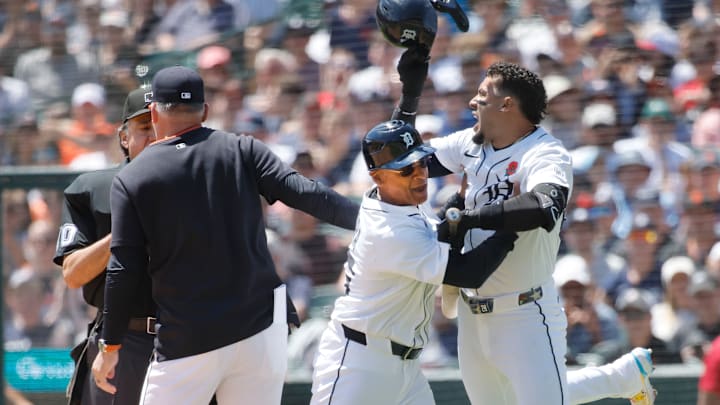 Detroit Tigers outfielder Javier Baez is held back from home plate umpire Phil Cuzzi after being ejected from the game. 