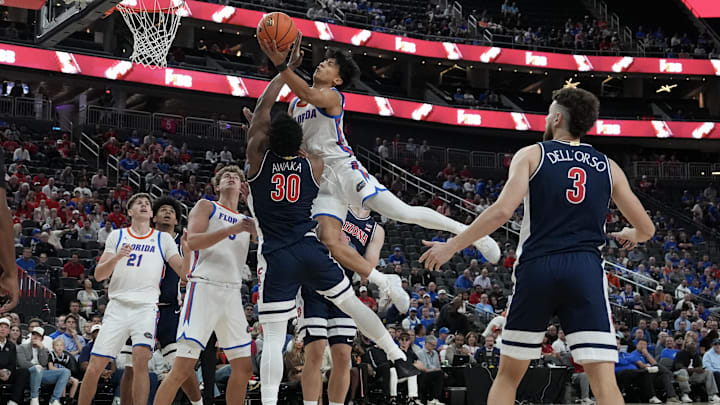 Nov 3, 2025; Las Vegas, NV, USA; Florida Gators guard Xaivian Lee (1) collides with Arizona Wildcats forward Tobe Awaka (30) during the first half of the Hall of Fame Series game at T-Mobile Arena. Mandatory Credit: Candice Ward-Imagn Images