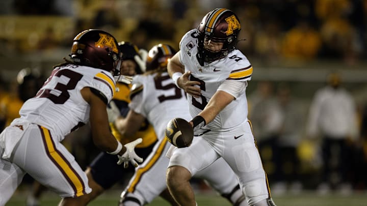Sep 13, 2025; Berkeley, California, USA; Minnesota Golden Gophers quarterback Drake Lindsey (5) hands off to running back Cam Davis (23) during the first quarter  against the California Golden Bears at California Memorial Stadium. Mandatory Credit: D. Ross Cameron-Imagn Images