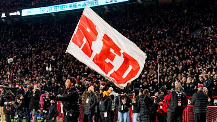 Nov 1, 2025; Lincoln, Nebraska, USA; A Nebraska Cornhuskers cheerleader carries a flag across the field after a score against the Southern California Trojans during the fourth quarter at Memorial Stadium. 