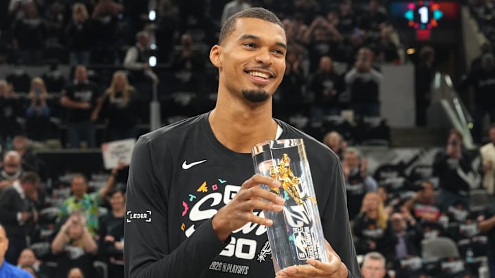 Apr 21, 2026; San Antonio, Texas, USA; San Antonio Spurs forward Victor Wembanyama (1) holds up his Defensive Player of the Year award before game two of the first round of the 2026 NBA Playoffs against the Portland Trail Blazers at Frost Bank Center. Mandatory Credit: Scott Wachter-Imagn Images