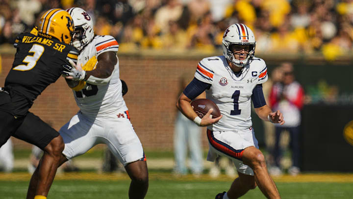 Oct 19, 2024; Columbia, Missouri, USA; Auburn Tigers quarterback Payton Thorne (1) runs the ball against Missouri Tigers safety Sidney Williams (3) during the first half at Faurot Field at Memorial Stadium. Mandatory Credit: Jay Biggerstaff-Imagn Images Oct 19, 2024; Columbia, Missouri, USA; Auburn Tigers quarterback Payton Thorne (1) runs the ball against Missouri Tigers safety Sidney Williams (3) during the first half at Faurot Field at Memorial Stadium. Mandatory Credit: Jay Biggerstaff-Imagn Images
