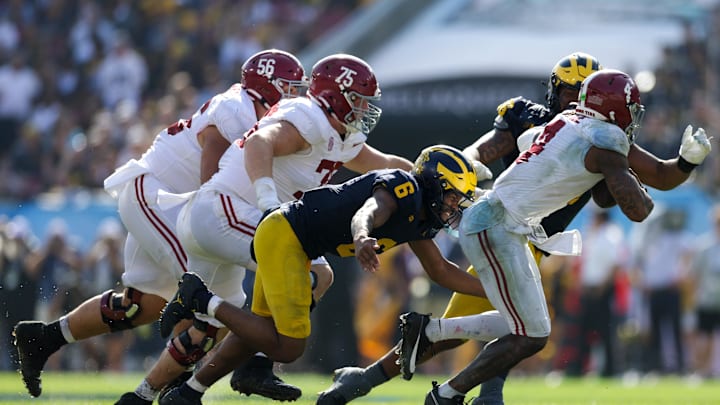 Dec 31, 2024; Tampa, FL, USA;  Alabama Crimson Tide quarterback Jalen Milroe (4) is sacked by Michigan Wolverines defensive back Brandyn Hillman (6) in the third quarter during the ReliaQuest Bowl at Raymond James Stadium. Mandatory Credit: Nathan Ray Seebeck-Imagn Images