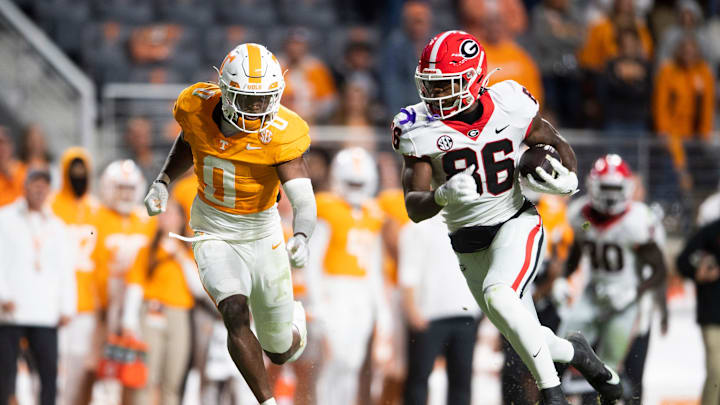 Georgia wide receiver Dillon Bell (86) runs the ball while defended by Tennessee defensive back Doneiko Slaughter (0) during a football game between Tennessee and Georgia at Neyland Stadium in Knoxville, Tenn., on Saturday, Nov. 18, 2023.