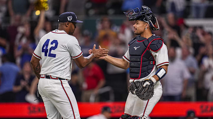 Apr 15, 2026; Cumberland, Georgia, USA; Atlanta Braves pitcher Raisel Iglesias (26) reacts with catcher Drake Baldwin (30) after the Braves defeated the Miami Marlins at Truist Park. All players are wearing number 42 today in honor of Jackie Robinson. Mandatory Credit: Dale Zanine-Imagn Images