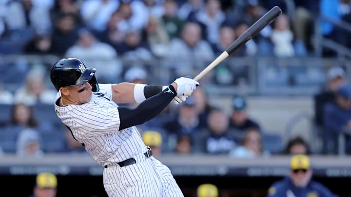 Mar 27, 2025; Bronx, New York, USA; New York Yankees right fielder Aaron Judge (99) follows through on an RBI double against the Milwaukee Brewers during the seventh inning at Yankee Stadium.
