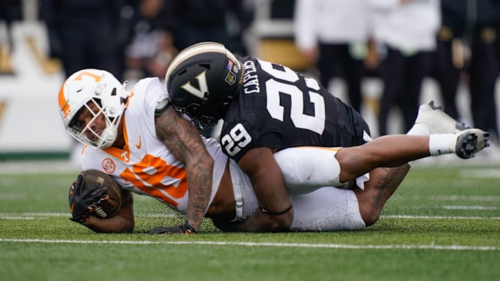 Tennessee running back DeSean Bishop (18) is stopped by Vanderbilt edge Miles Capers (29) during the third quarter at FirstBank Stadium in Nashville, Tenn., Saturday, Nov. 30, 2024. Tennessee running back DeSean Bishop (18) is stopped by Vanderbilt edge Miles Capers (29) during the third quarter at FirstBank Stadium in Nashville, Tenn., Saturday, Nov. 30, 2024.