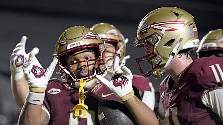 Oct 5, 2024; Tallahassee, Florida, USA; Florida State Seminoles wide receiver Ja'Khi Douglas (0) celebrates with quarterback Brock Glenn (11) after a touchdown against the Clemson Tigers during the second half at Doak S. Campbell Stadium. Mandatory Credit: Melina Myers-Imagn Images