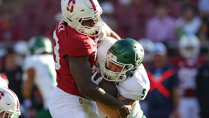 Sep 7, 2024; Stanford, California, USA; Cal Poly Mustangs running back Aiden Ramos (5) is tackled by Stanford Cardinal linebacker David Bailey (23) during the second half at Stanford Stadium. Mandatory Credit: Sergio Estrada-Imagn Images
