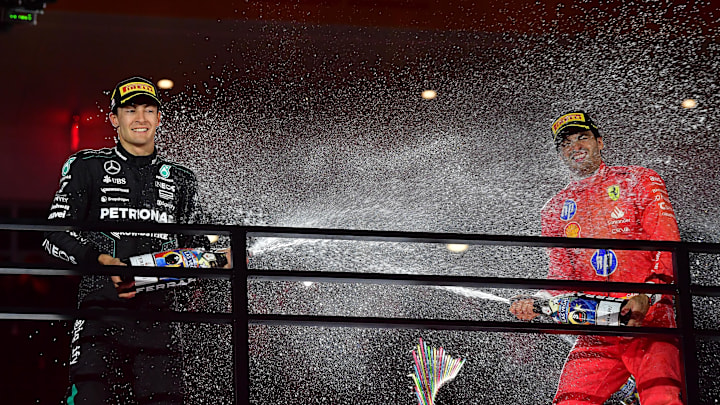 Nov 23, 2024; Las Vegas, Nevada, USA; Mercedes AMG Petronas driver George Russell (63) and Scuderia Ferrari driver Carlos Sainz (55) celebrate their podium finish at the Las Vegas Grand Prix at Las Vegas Circuit. Mandatory Credit: Gary A. Vasquez-Imagn Images