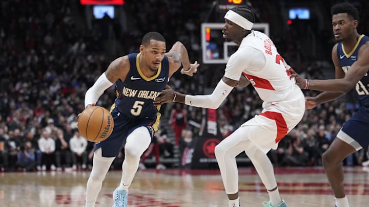 Jan 27, 2025; Toronto, Ontario, CAN; New Orleans Pelicans guard Dejounte Murray (5) drives to the basket past Toronto Raptors forward Chris Boucher (25) during the second half at Scotiabank Arena. Mandatory Credit: John E. Sokolowski-Imagn Images