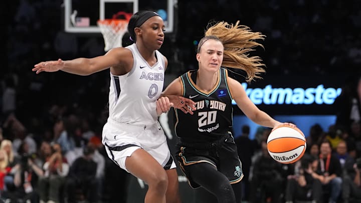Sep 29, 2024; Brooklyn, New York, USA; New York Liberty guard Sabrina Ionescu (20) dribbles the ball against Las Vegas Aces guard Jackie Young (0) during game one of the 2024 WNBA Semi-finals at Barclays Center. Mandatory Credit: Gregory Fisher-Imagn Images