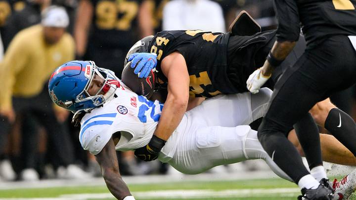 Oct 10, 2026; Nashville, Tennessee, USA;  Vanderbilt Commodores linebacker Nick Rinaldi (24) tackles Mississippi Rebels wide receiver Cameron Miller (22) during the first half at FirstBank Stadium.  Mandatory Credit: Steve Roberts-Imagn Images