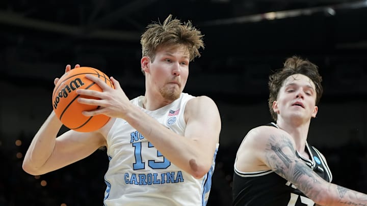 Mar 19, 2026; Greenville, SC, USA; North Carolina Tar Heels center Henri Veesaar (13) rebounds the ball against VCU Rams forward Lazar Djokovic (17) in the first half of a first round game of the men's 2026 NCAA Tournament at Bon Secours Wellness Arena. Mandatory Credit: Bob Donnan-Imagn Images
