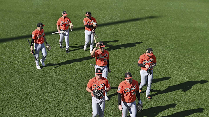 Feb 10, 2026; Scottsdale, AZ, USA;  Members of the San Francisco Giants walk across the field during a Spring Training workout at Scottsdale Stadium Mandatory Credit: Matt Kartozian-Imagn Images