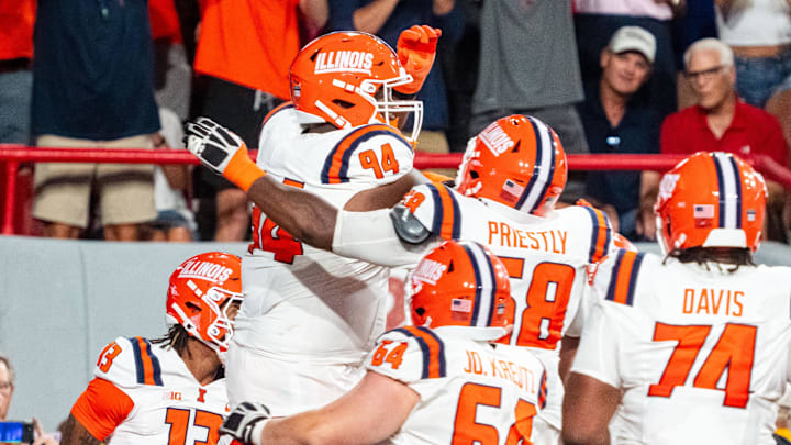 Sep 20, 2024; Lincoln, Nebraska, USA; Illinois Fighting Illini offensive lineman Brandon Henderson (94) celebrates with teammates after scoring a touchdown against the Nebraska Cornhuskers during the fourth quarter at Memorial Stadium.