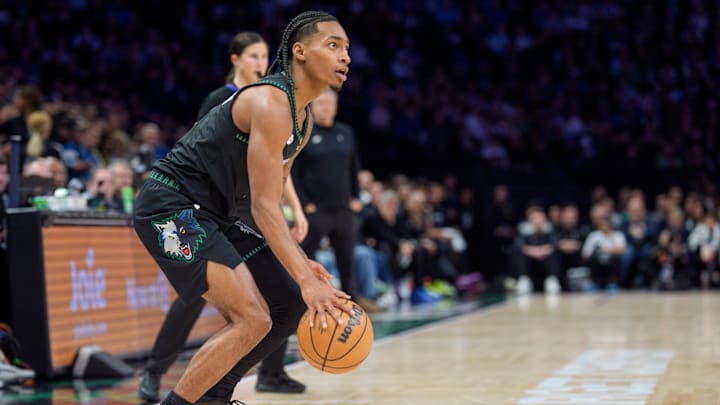 Dec 6, 2025; Minneapolis, Minnesota, USA; Minnesota Timberwolves guard Rob Dillingham (4) sets up a three point attempt against the LA Clippers in the second quarter at Target Center.