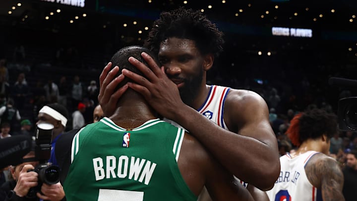 Philadelphia 76ers center Joel Embiid (21) talks with Boston Celtics guard Jaylen Brown (7) following game seven of the first round of the 2026 NBA Playoffs at TD Garden. 
