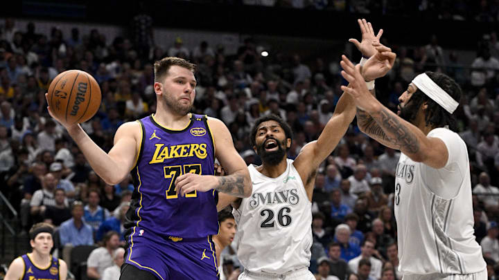 Apr 9, 2025; Dallas, Texas, USA; Los Angeles Lakers guard Luka Doncic (77) passes the ball by Dallas Mavericks guard Spencer Dinwiddie (26) and forward Anthony Davis (3) during the third quarter at the American Airlines Center. Mandatory Credit: Jerome Miron-Imagn Images