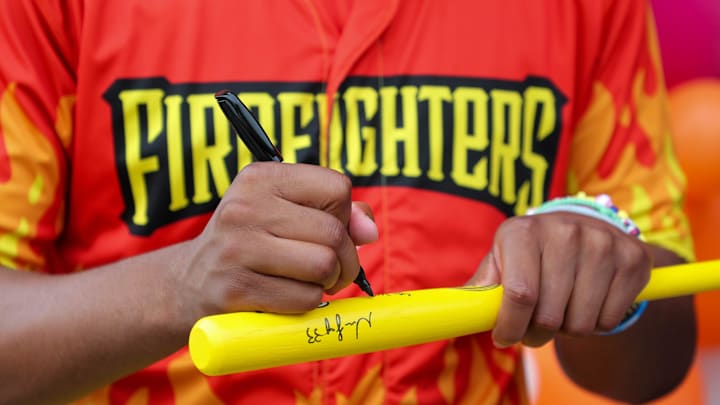 Firefighters player Ga'von Wray autographs a bat during a Banana Ball takeover at Dunkin' Donuts on Saturday, August 23, 2025 in Savannah.