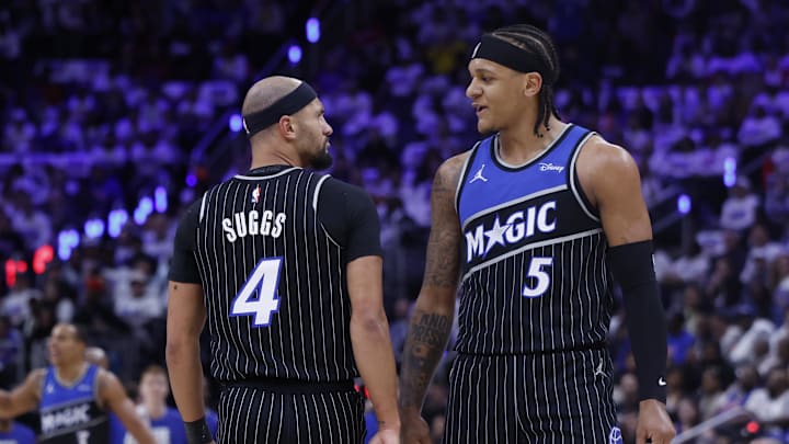 Magic guard Jalen Suggs and forward Paolo Banchero talk during a timeout in the first half against the Pistons.