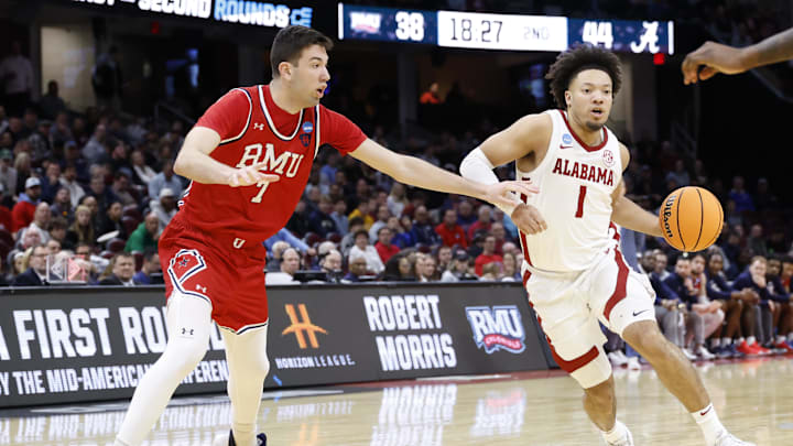 Mar 21, 2025; Cleveland, OH, USA; Alabama Crimson Tide guard Mark Sears (1) dribbles defended by Robert Morris Colonials forward Alvaro Folgueiras (7) in the second half  during the NCAA Tournament First Round at Rocket Arena. Mandatory Credit: Rick Osentoski-Imagn Images