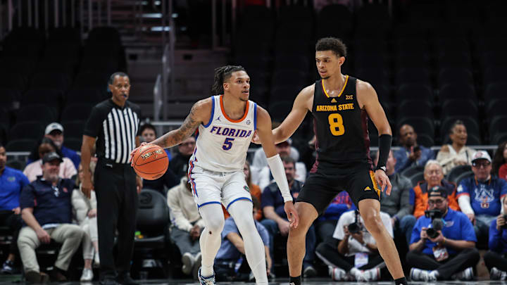 Dec 14, 2024; Atlanta, Georgia, USA; Florida Gators guard Will Richard (5) controls the ball against Arizona State Sun Devils forward Basheer Jihad (8) during the second half at State Farm Arena. Mandatory Credit: Jordan Godfree-Imagn Images