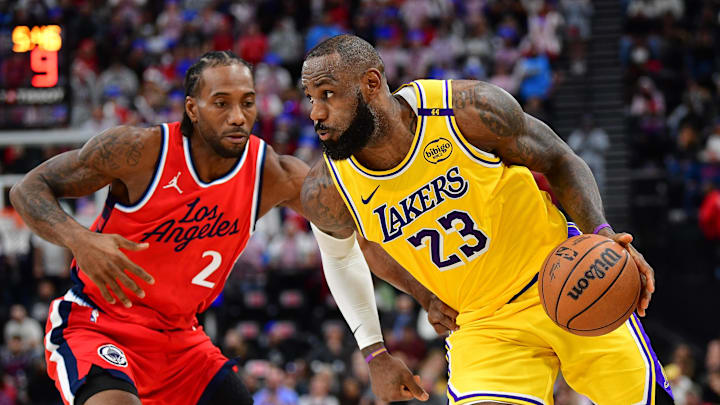 Feb 4, 2025; Inglewood, California, USA; Los Angeles Lakers forward LeBron James (23) moves the ball against Los Angeles Clippers forward Kawhi Leonard (2) during the second half at Intuit Dome. Mandatory Credit: Gary A. Vasquez-Imagn Images