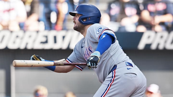 Texas Rangers first baseman Jake Burger (21) hits an RBI single during the third inning against the Cleveland Guardians at Progressive Field. 