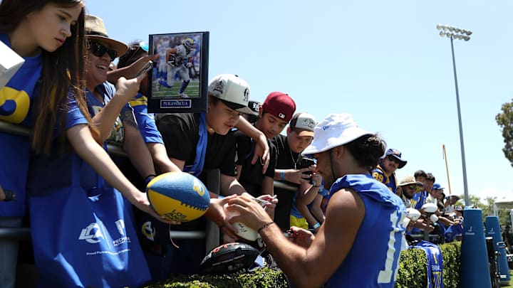 Jul 31, 2024; Los Angeles, CA, USA; Los Angeles Rams wide receiver Puka Nacua (17) signs autographs after training camp at Loyola Marymount University. Mandatory Credit: Kiyoshi Mio-Imagn Images Jul 31, 2024; Los Angeles, CA, USA; Los Angeles Rams wide receiver Puka Nacua (17) signs autographs after training camp at Loyola Marymount University. Mandatory Credit: Kiyoshi Mio-Imagn Images