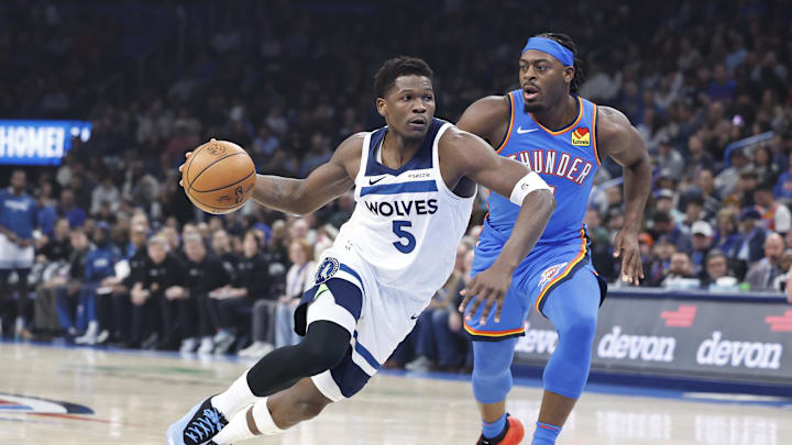 Dec 31, 2024; Oklahoma City, Oklahoma, USA; Minnesota Timberwolves guard Anthony Edwards (5) drives to the basket beside Oklahoma City Thunder guard Luguentz Dort (5) during the first quarter at Paycom Center. Mandatory Credit: Alonzo Adams-Imagn Images