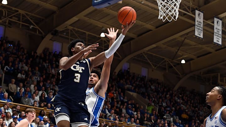 Dec 31, 2025; Durham, North Carolina, USA; Georgia Tech Yellow Jackets guard Jaeden Mustaf (3) lays the ball up in front of Duke Blue Devils forward Cameron Boozer (12)during the first half at Cameron Indoor Stadium. Mandatory Credit: Rob Kinnan-Imagn Images