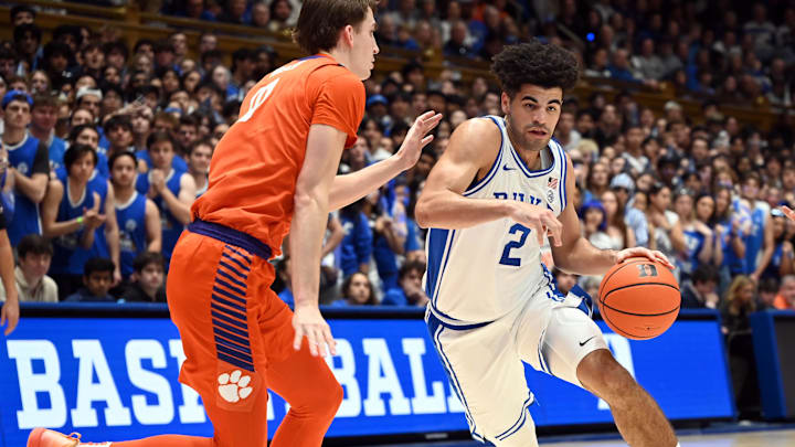 Feb 14, 2026; Durham, North Carolina, USA; Duke Blue Devils guard Cayden Boozer (2) drives to the basket as Clemson Tigers center Nick Davidson (11) defends during the second half at Cameron Indoor Stadium. Feb 14, 2026; Durham, North Carolina, USA; Duke Blue Devils guard Cayden Boozer (2) drives to the basket as Clemson Tigers center Nick Davidson (11) defends during the second half at Cameron Indoor Stadium.