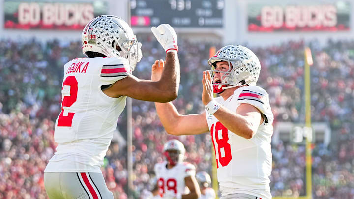 Ohio State Buckeyes wide receiver Emeka Egbuka (2) celebrates a touchdown catch with quarterback Will Howard (18) during the first half of the College Football Playoff quarterfinal against the Oregon Ducks at the Rose Bowl in Pasadena, Calif. on Jan. 1, 2025.