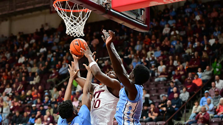 Mar 4, 2025; Blacksburg, Virginia, USA;  Virginia Tech Hokies guard Tyler Johnson (10) goes up for a shot as North Carolina Tar Heels forward Jalen Washington (13) defends during the first half at Cassell Coliseum. Mandatory Credit: Brian Bishop-Imagn Images