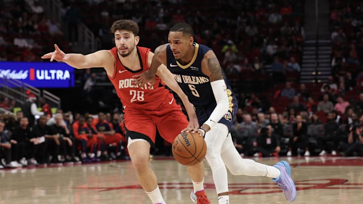 Dec 19, 2024; Houston, Texas, USA;  New Orleans Pelicans guard Dejounte Murray (5) dribbles past Houston Rockets center Alperen Sengun (28) in the first quarter at Toyota Center. Mandatory Credit: Thomas Shea-Imagn Images