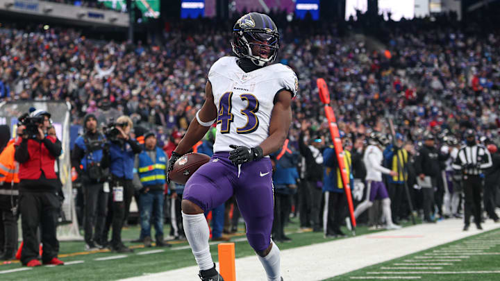 Dec 15, 2024; East Rutherford, New Jersey, USA; Baltimore Ravens running back Justice Hill (43) scores a touchdown reception during the second half against the New York Giants at MetLife Stadium. Mandatory Credit: Vincent Carchietta-Imagn Images