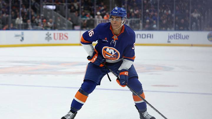 Jan 18, 2025; Elmont, New York, USA; New York Islanders defenseman Isaiah George (36) looks to move the puck against the San Jose Sharks during the second period at UBS Arena. Mandatory Credit: Thomas Salus-Imagn Images