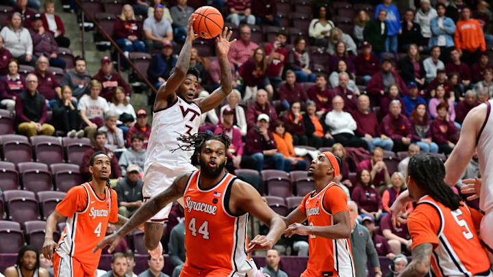 Mar 1, 2025; Blacksburg, Virginia, USA;  Virginia Tech Hokies guard Jaydon Young (3) looks to pass the ball against Syracuse Orange defenders during the second half at Cassell Coliseum. Mandatory Credit: Brian Bishop-Imagn Images