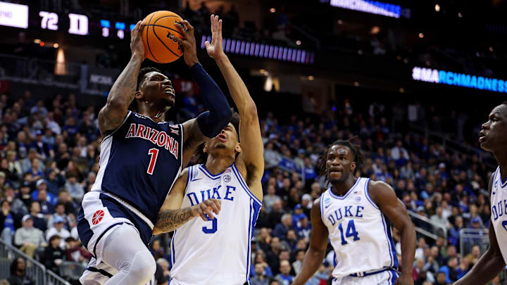 Mar 27, 2025; Newark, NJ, USA; Arizona Wildcats guard Caleb Love (1) shoots the ball against Duke Blue Devils guard Tyrese Proctor (5) during the second half during an East Regional semifinal of the 2025 NCAA tournament at Prudential Center. Mandatory Credit: Vincent Carchietta-Imagn Images