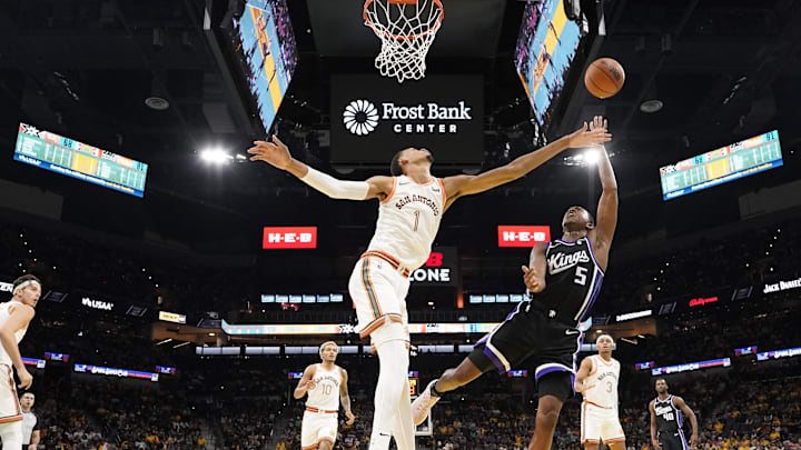 Nov 17, 2023; San Antonio, Texas, USA; Sacramento Kings guard De'Aaron Fox (5) shoots over San Antonio Spurs forward Victor Wembanyama (1) during the second half at Frost Bank Center. Mandatory Credit: Scott Wachter-Imagn Images
