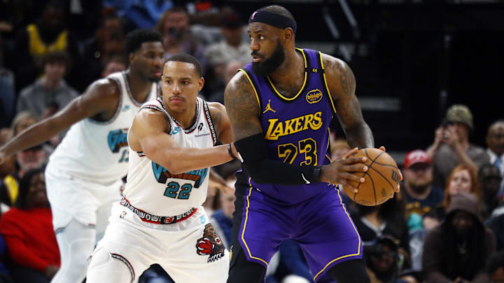 Mar 29, 2025; Memphis, Tennessee, USA; Los Angeles Lakers forward LeBron James (23) handles the ball as Memphis Grizzlies guard Desmond Bane (22) defends during the fourth quarter at FedExForum. Mandatory Credit: Petre Thomas-Imagn Images