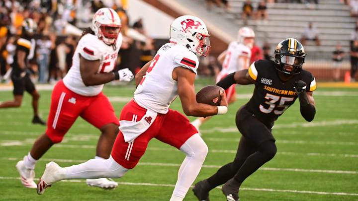 Jacksonville State Gamecocks quarterback Gavin Wimsatt (2) runs the ball against Southern Miss Golden Eagles linebacker Chris Jones (35) during the first quarter at M.M. Roberts Stadium in Hattiesburg, Miss. on Sept. 27, 2025.