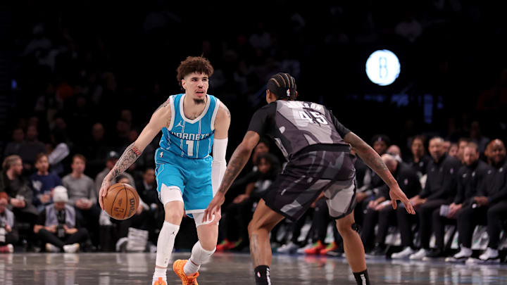 Feb 10, 2025; Brooklyn, New York, USA; Charlotte Hornets guard LaMelo Ball (1) brings the ball up court against Brooklyn Nets guard Keon Johnson (45) during the first quarter at Barclays Center. Mandatory Credit: Brad Penner-Imagn Images