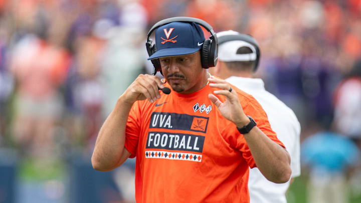 Sept 9, 2023; Charlottesville, Virginia, USA; Head Coach Tony Elliot discussing plays over the headset to his players during the second half against the James Madison Dukes at Scott Stadium. Mandatory Credit: Hannah Pajewski-Imagn Images Sept 9, 2023; Charlottesville, Virginia, USA; Head Coach Tony Elliot discussing plays over the headset to his players during the second half against the James Madison Dukes at Scott Stadium. Mandatory Credit: Hannah Pajewski-Imagn Images