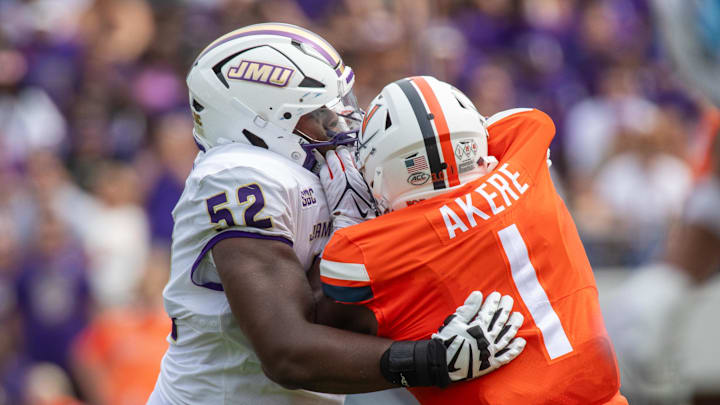 September 9, 22023 in Charlottesville, Virginia; James Madison Dukes offensive lineman Tyshawn Wyatt (52) blocks Virginia Cavaliers defensive end Paul Akere (1) during the first half of the game at Scott Stadium. Mandatory Credit: Hannah Pajewski-Imagn Images September 9, 22023 in Charlottesville, Virginia; James Madison Dukes offensive lineman Tyshawn Wyatt (52) blocks Virginia Cavaliers defensive end Paul Akere (1) during the first half of the game at Scott Stadium. Mandatory Credit: Hannah Pajewski-Imagn Images